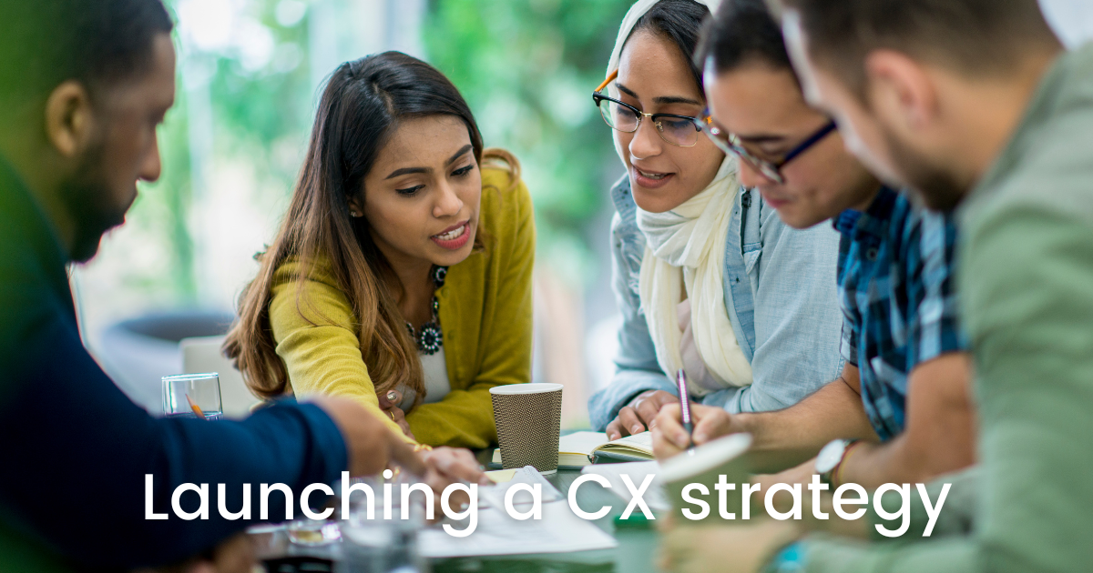 business team brainstorming with text saying launching a cx strategy