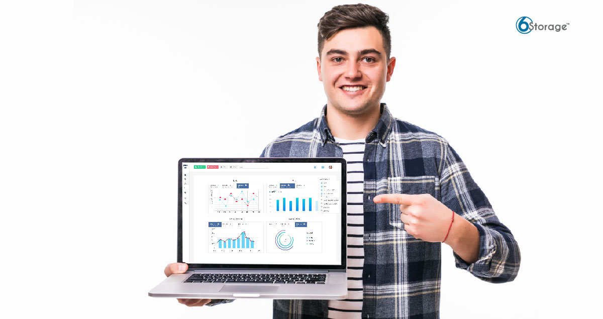 man holding laptop showing 6Storage self-storage software