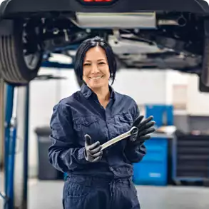 Automotive repair shop female technician holding clipboard
