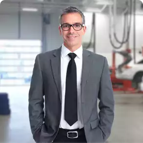 male automotive dealer in suit and tie