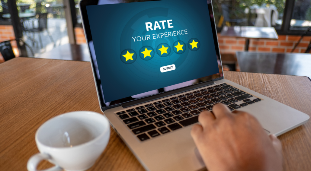 Rate your experience laptop showing customer looking at a 5-star rating